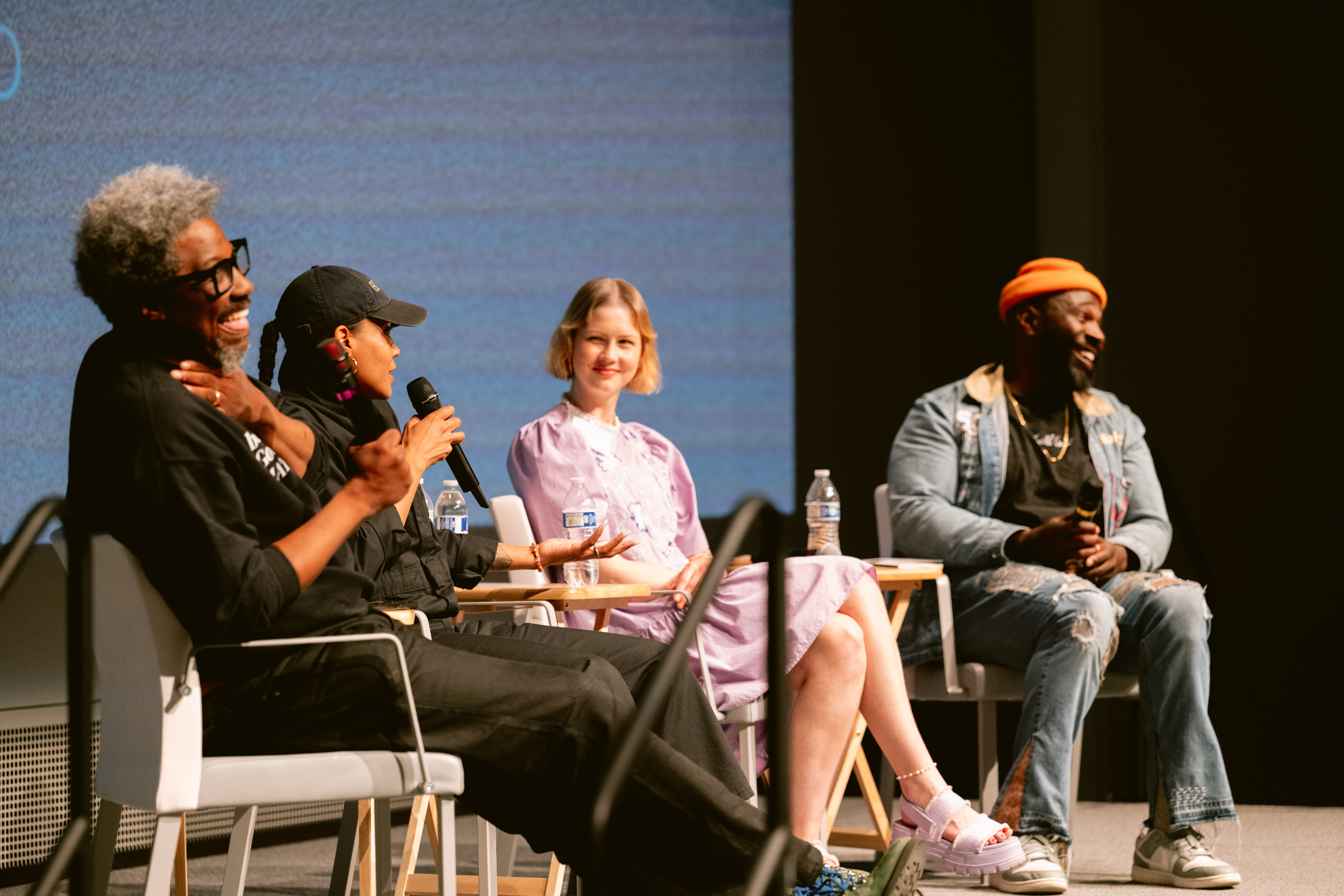 people discussing topics sitting on a stage